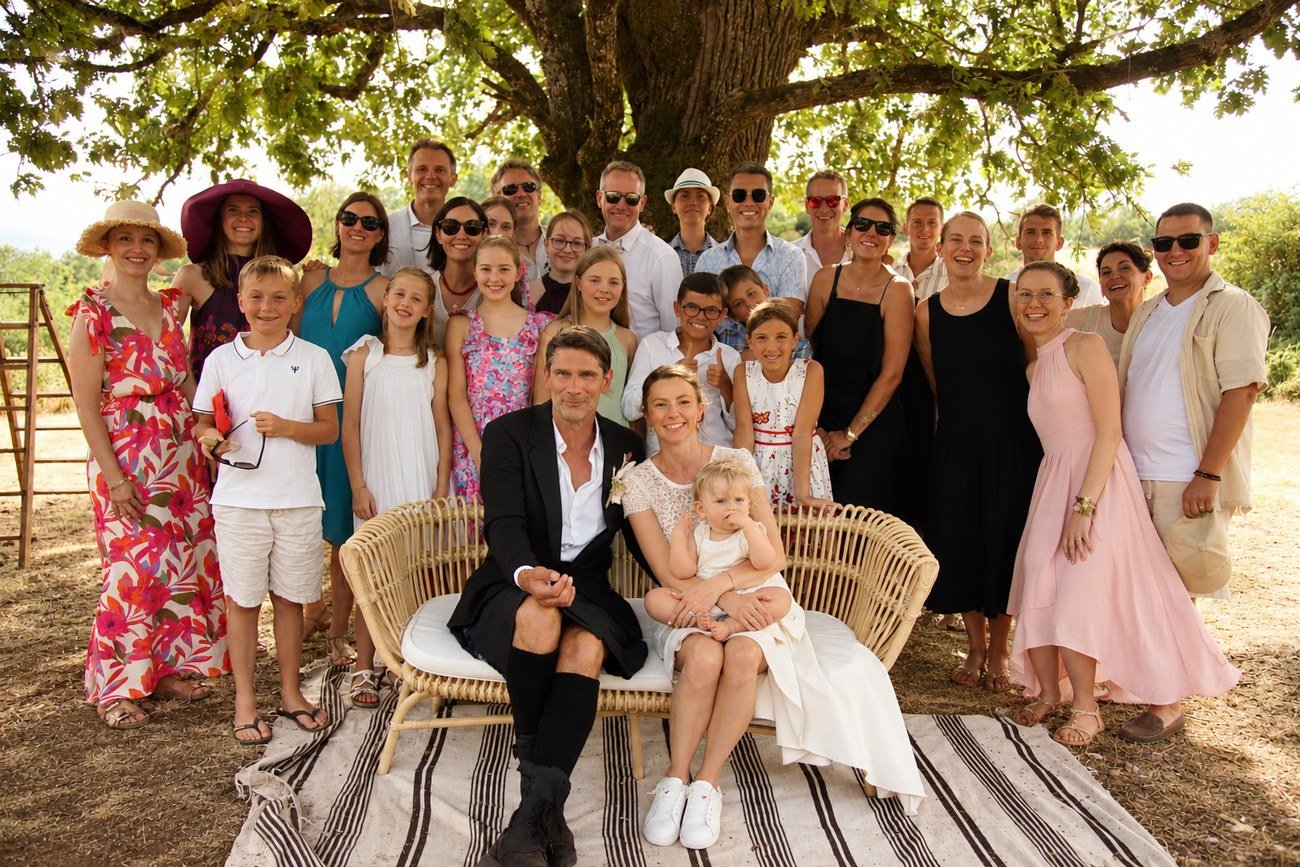 Full wedding party and extended family group portrait under a large oak tree